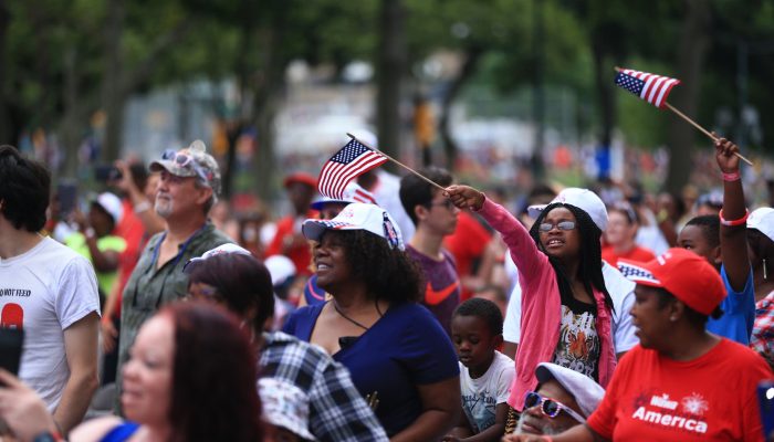 group of people waving american flags