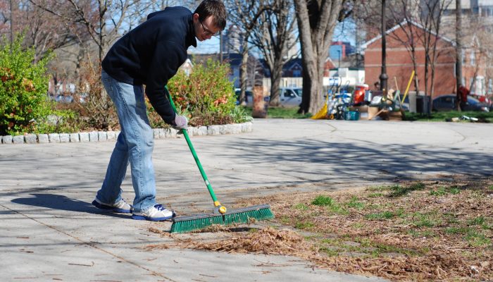 A person sweeps a park walkway
