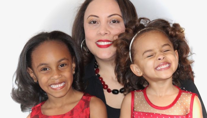 PHLpreK graduate Brooke smiles with her mother and sister.