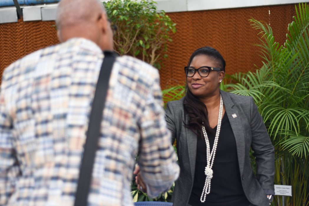 Two people shaking hands at a networking event.
