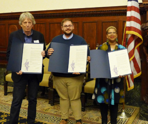 Three honorees holding City proclamations, and a group of young students from Mighty Writers. 