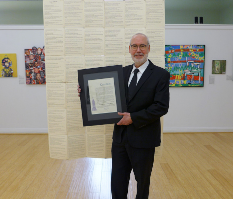 Man poses with City Citation