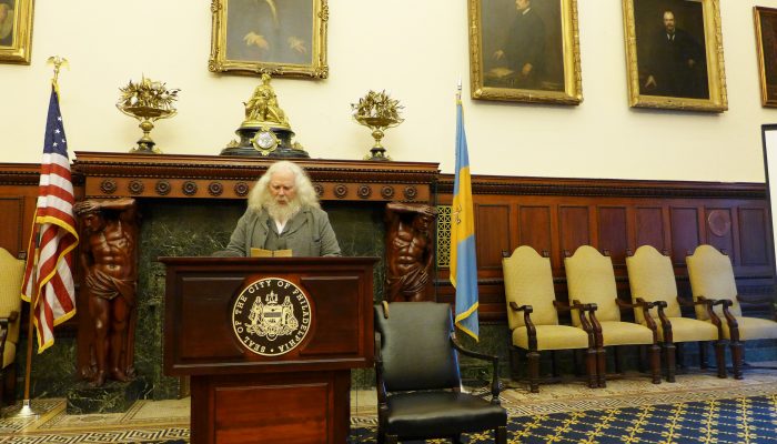 Walt Whitman impersonator standing at a podium.