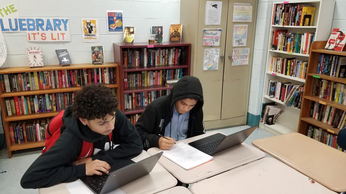 Xavier Burgos and Keven Lopez, ninth-graders at Kensington Health Sciences Academy applying for summer jobs on computers.