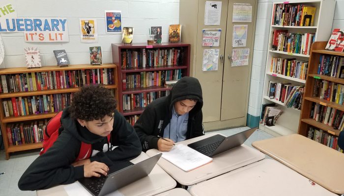 Xavier Burgos and Keven Lopez, ninth-graders at Kensington Health Sciences Academy applying for summer jobs on computers.