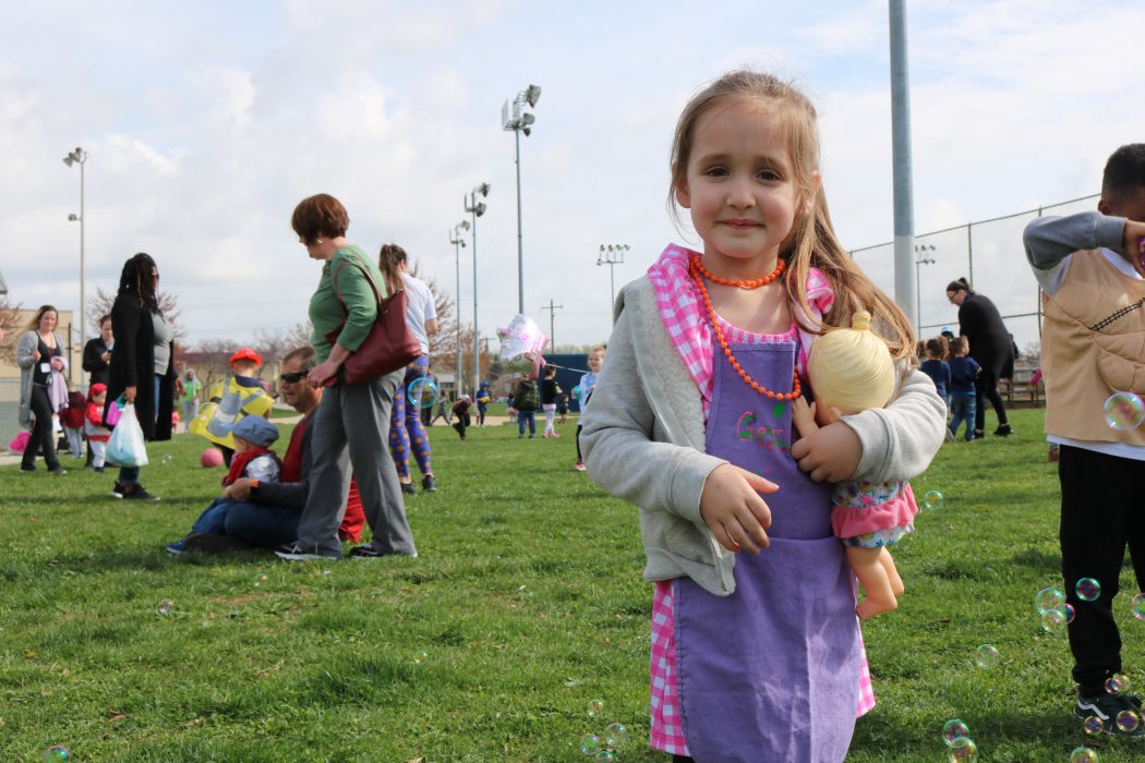 PHLpreK student Gemma standing and smiling at the 2019 Week of the Young Child parade.