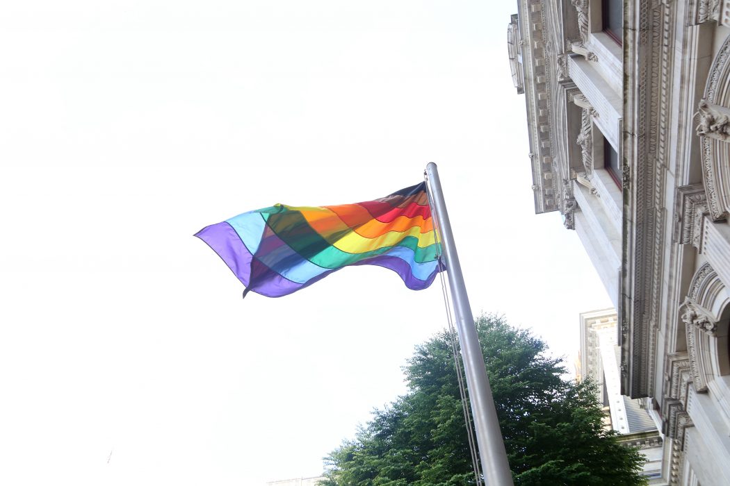 More Color, More Pride LGBTQ Pride flag on flag pole.