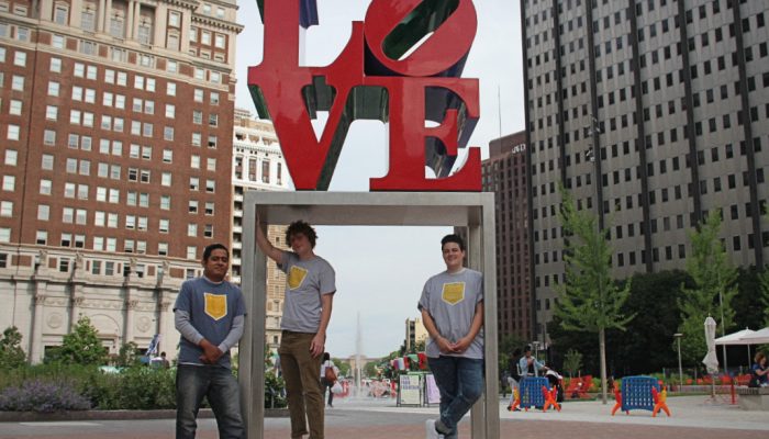 Three members of the Philly Reading Coaches staff pose in front of the LOVE Statue.