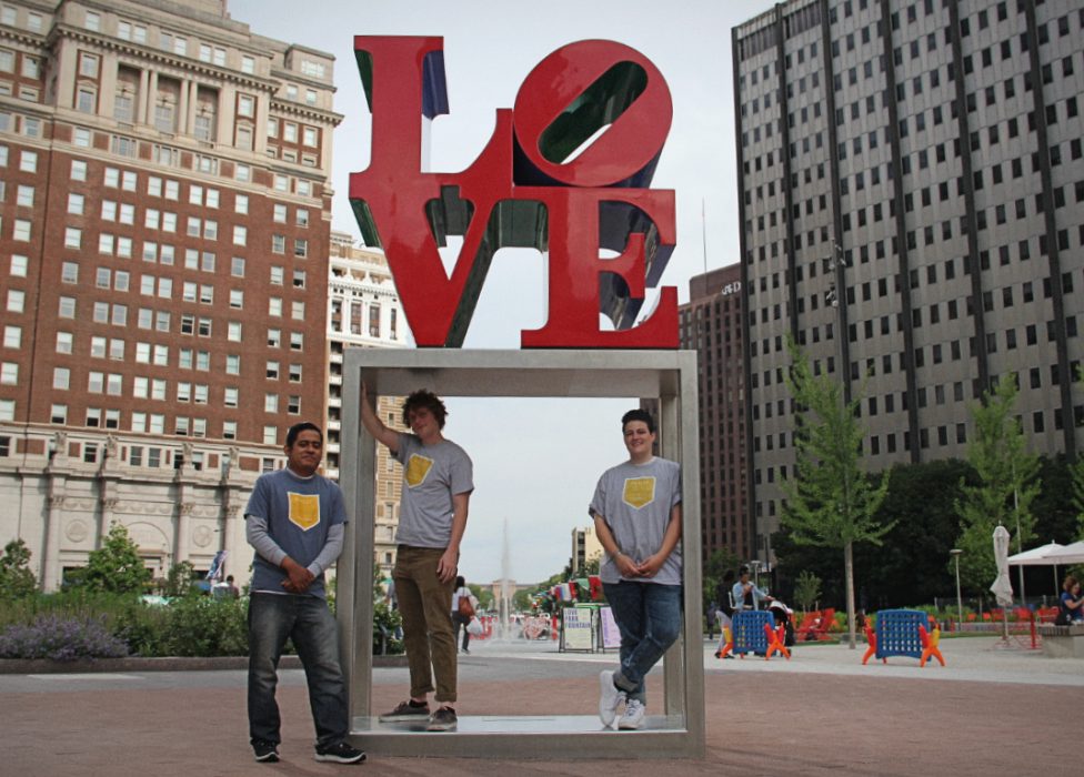 Three members of the Philly Reading Coaches staff pose in front of the LOVE Statue.
