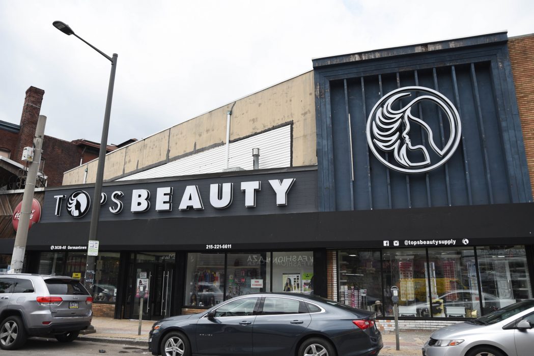 The exterior of North Philadelphia-based Tops Beauty Supply, featuring new awnings, windows, and signage.