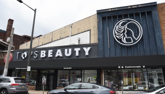 The exterior of North Philadelphia-based Tops Beauty Supply, featuring new awnings, windows, and signage.