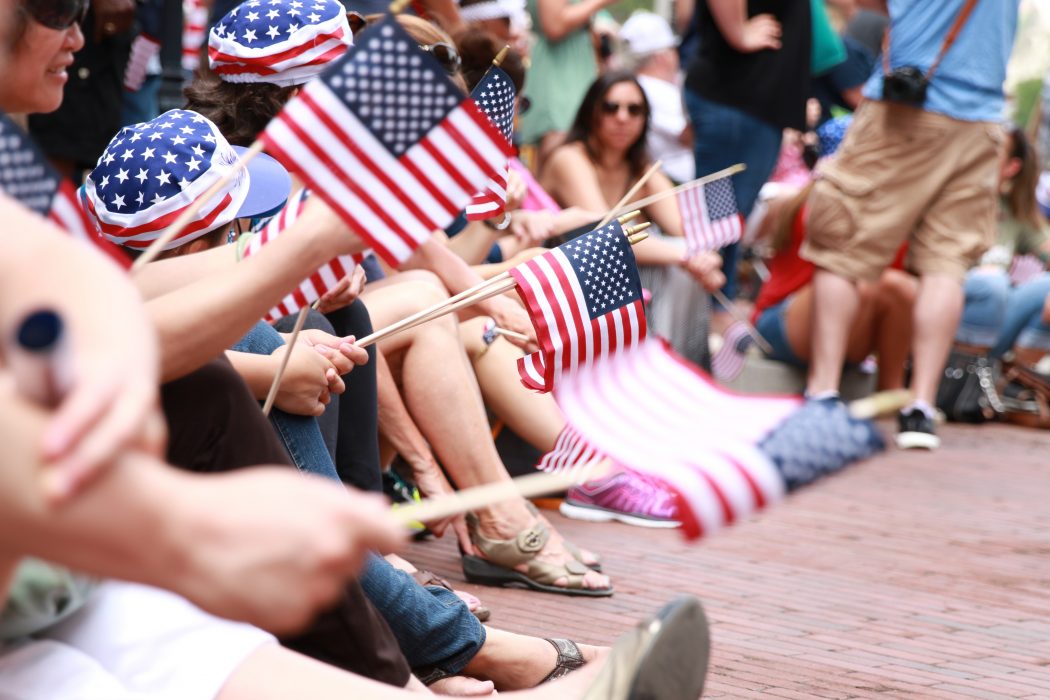 people waving miniature american flags
