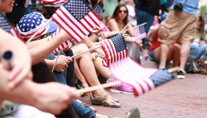 people waving miniature american flags