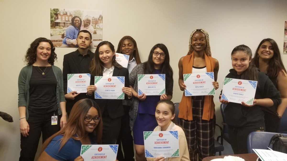 Healthy Communities Interns stand smiling, holding their certificates of achievement