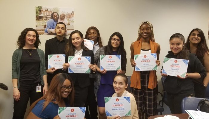 Healthy Communities Interns stand smiling, holding their certificates of achievement