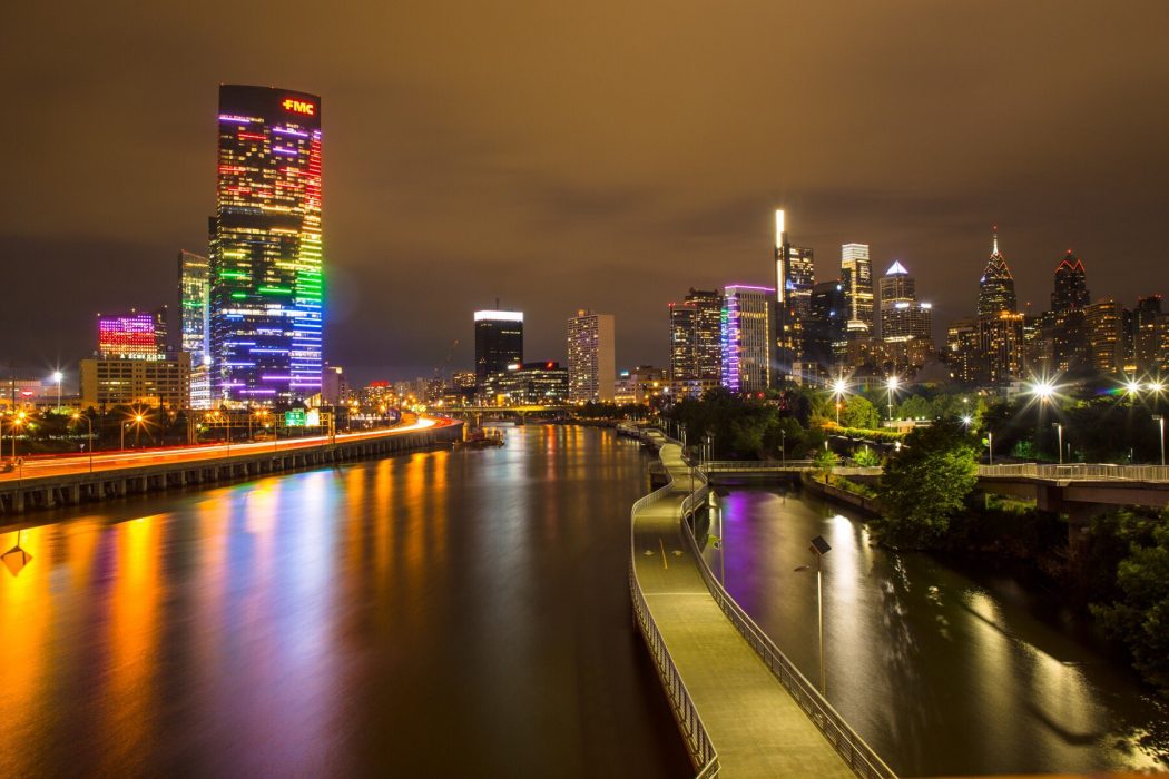 Buildings in Philadelphia skyline lit up in rainbow colors.