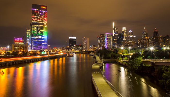 Buildings in Philadelphia skyline lit up in rainbow colors. 