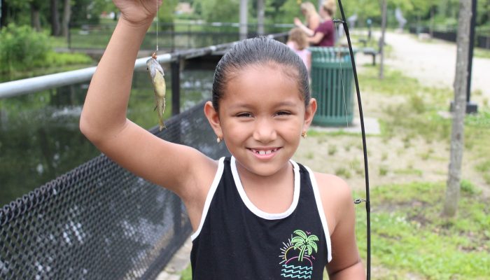 child fishing at Pleasant Hill Park fish hatchery.