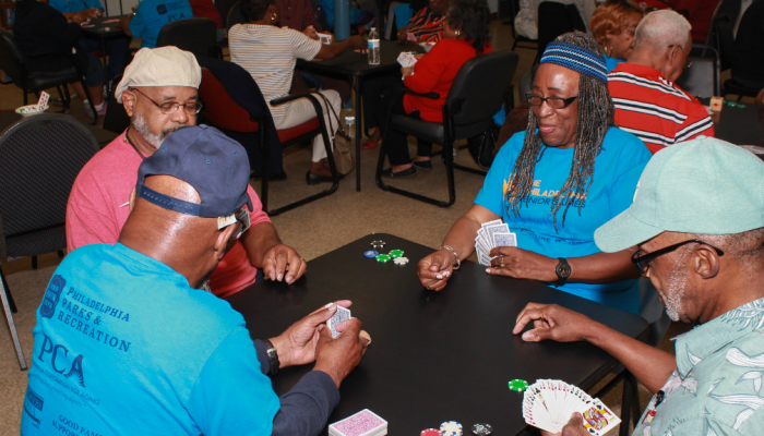 Four senior citizens play poker at an older adult center in Philadelphia