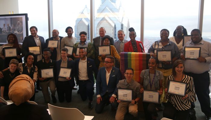 Group of people holding certificates.