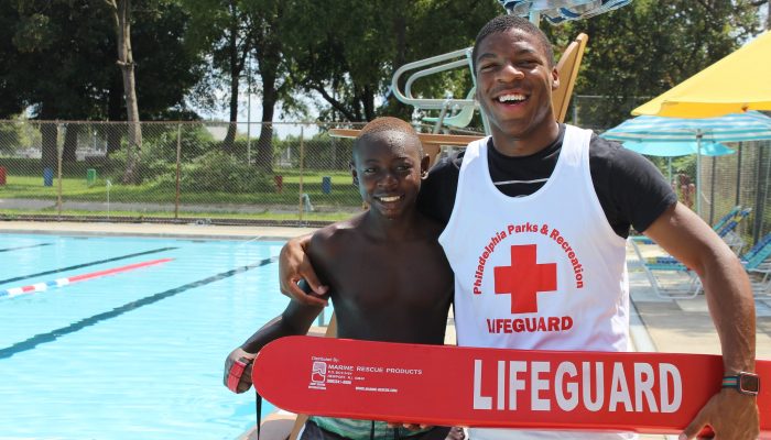 Child and lifeguard at the pool.