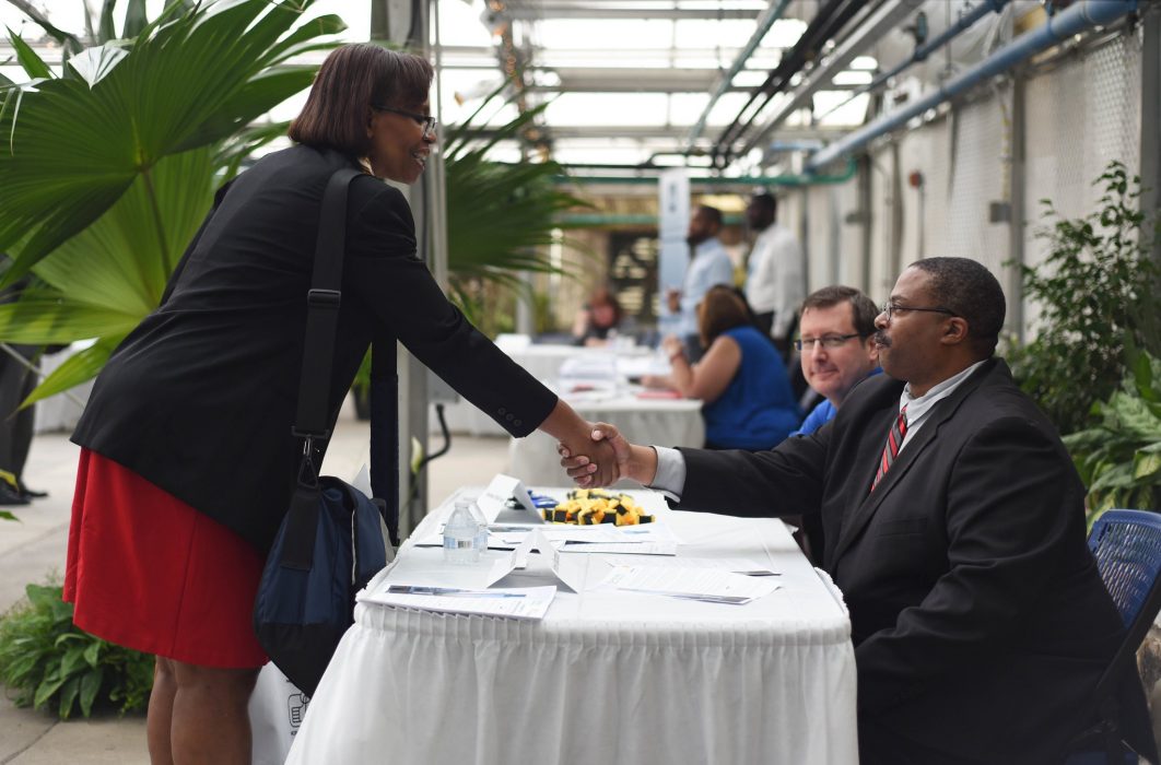 People shaking hands at a job fair
