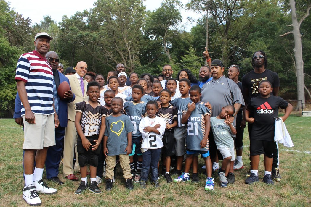 Parents and team members from the Parkside Saints celebrate their new athletic field