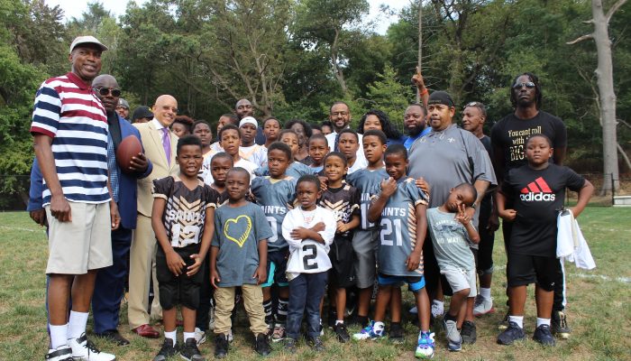 Parents and team members from the Parkside Saints celebrate their new athletic field