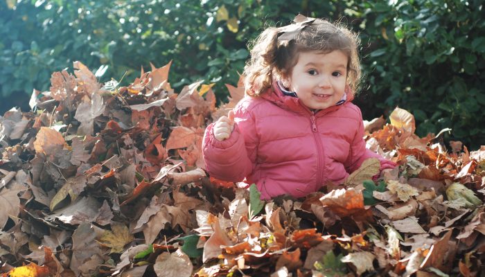 child enjoying fall foliage.