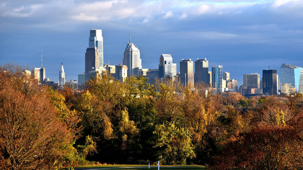 The Philadelphia skyline in the background, with Fairmount Park trees in the foreground