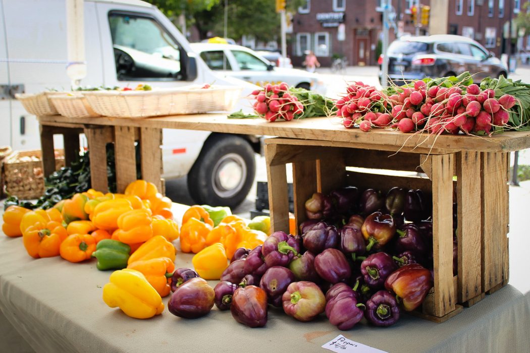 Peppers and other vegetables spill out of a crate at a farmer's market in a Philadelphia neighborhood where they accept food stamps.