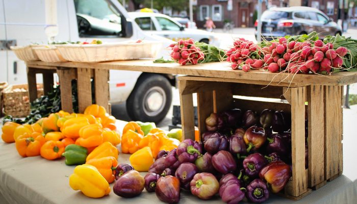 Peppers and other vegetables spill out of a crate at a farmer's market in a Philadelphia neighborhood where they accept food stamps.