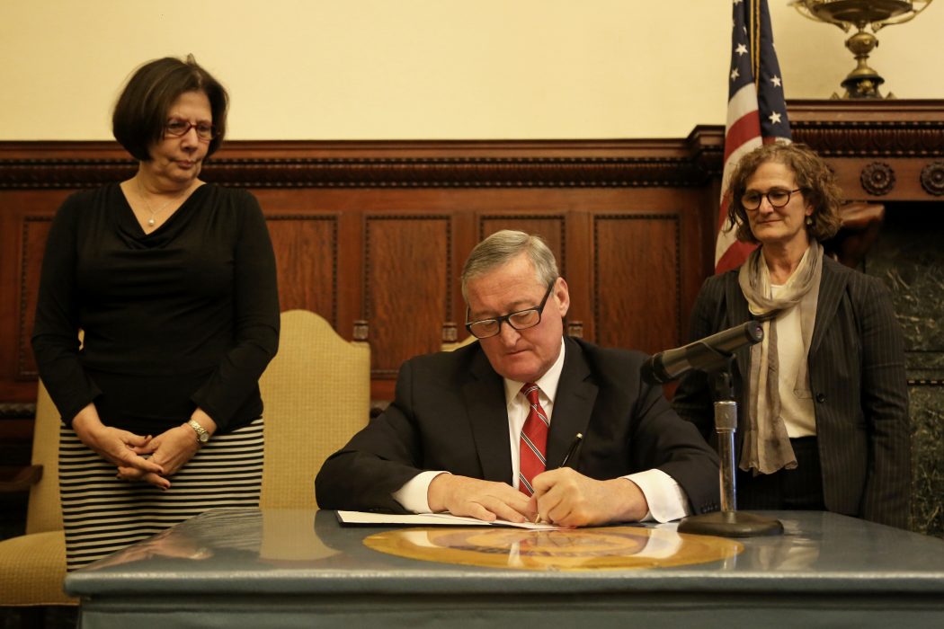 Mayor Kenney signing the Whistleblower Executive Order with Chief Integrity Officer Ellen Kaplan to his right and Inspector General Amy Kurland to his left.