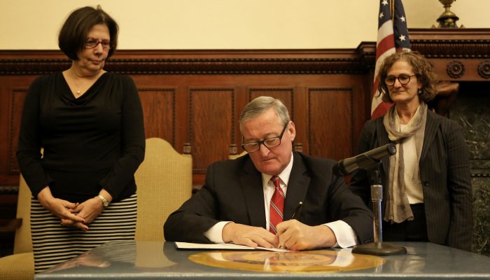 Mayor Kenney signing the Whistleblower Executive Order with Chief Integrity Officer Ellen Kaplan to his right and Inspector General Amy Kurland to his left.