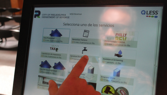A Philly water customer follows Spanish-language prompts on a customer service kiosk in the Municipal Services Building