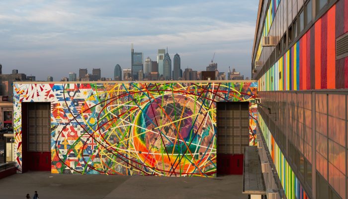 The philadelphia skyline with a mural in the foreground