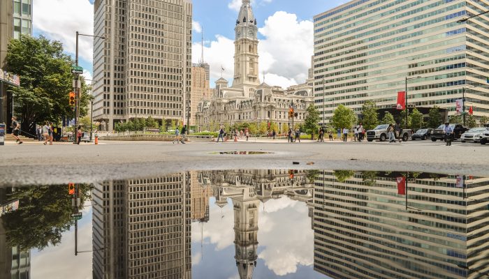 city hall reflected in water from the love park fountain