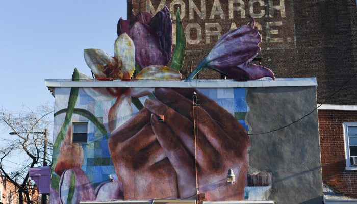 Mural of two hands holding flowers.