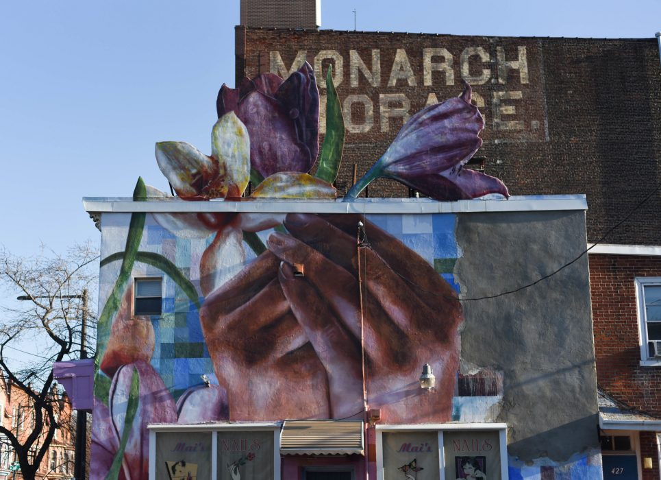 Mural of two hands holding flowers.