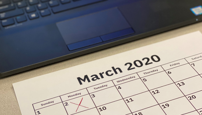March 2020 calendar in front of laptop