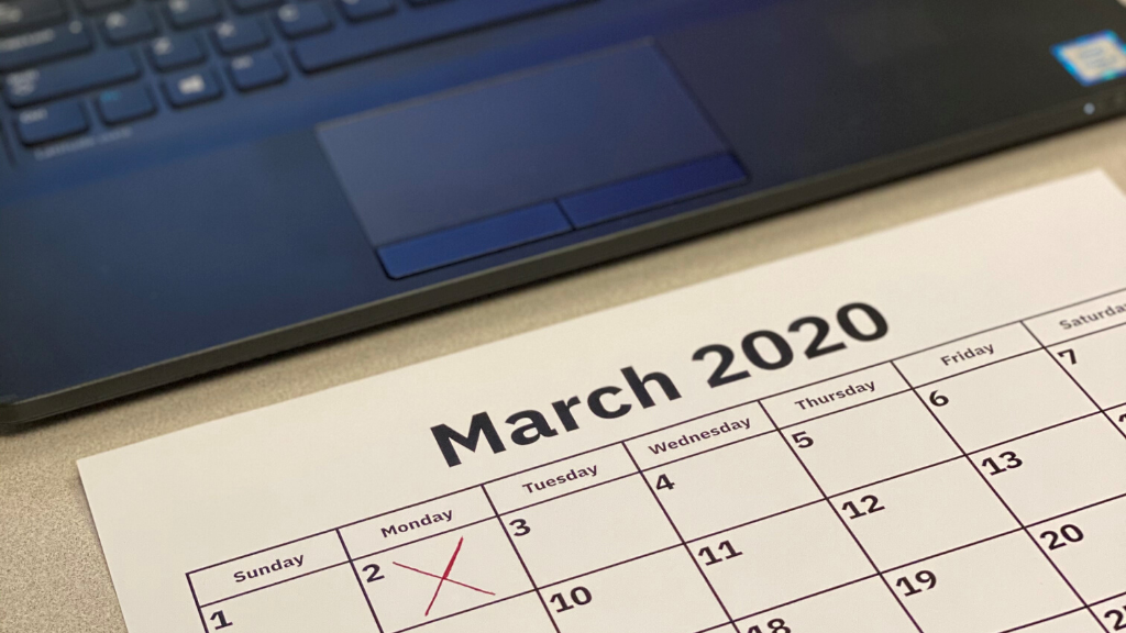 March 2020 calendar in front of laptop