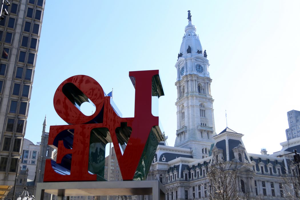 the love sculpture with Philadelphia city hall in the background