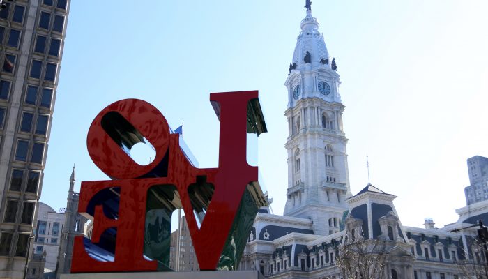 the love sculpture with Philadelphia city hall in the background