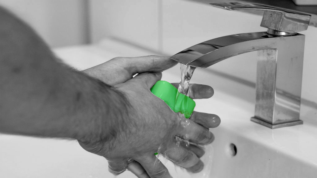 Person washing hands in sink