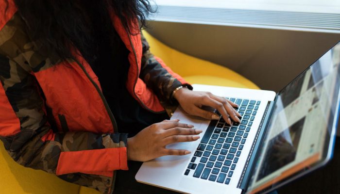 Woman browses website on her laptop