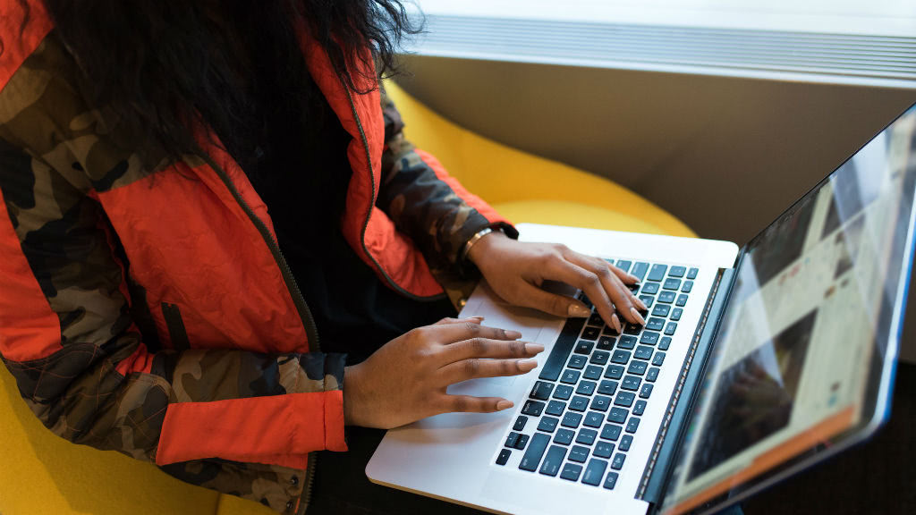 Woman browses website on her laptop