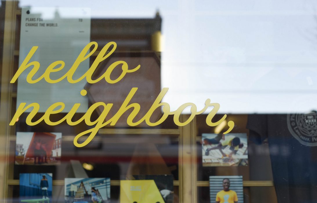 storefront window that says hello neighbor