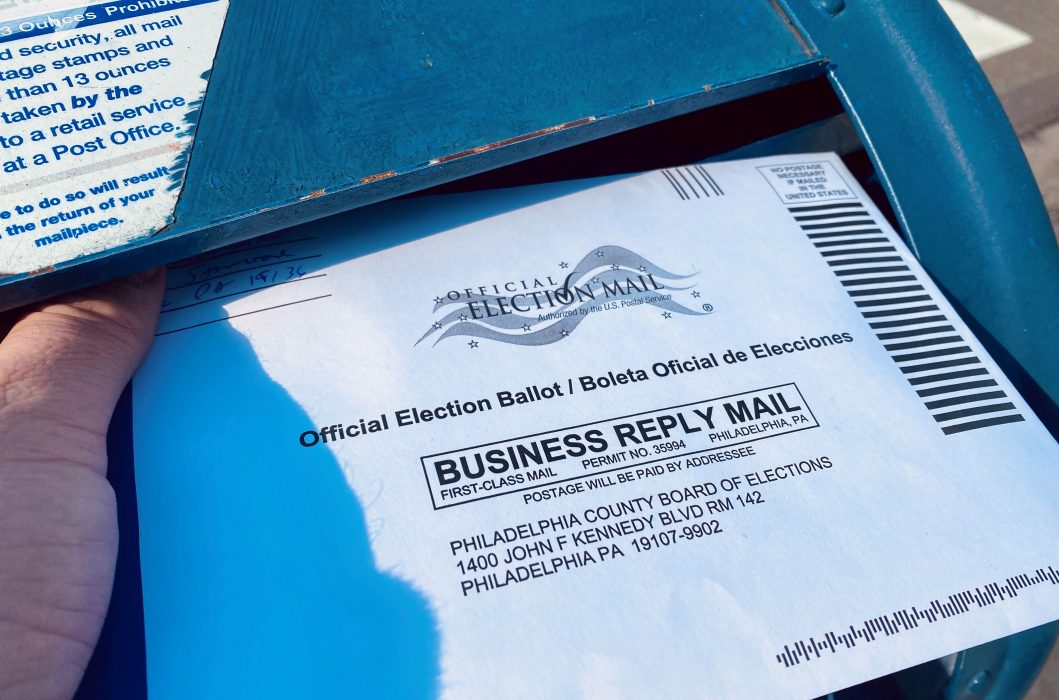 a person mailing in their ballot
