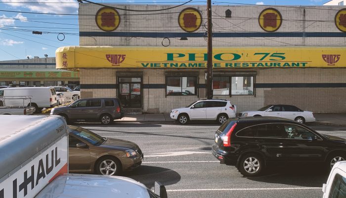 Cars drive in front of PHO 75 restaurant