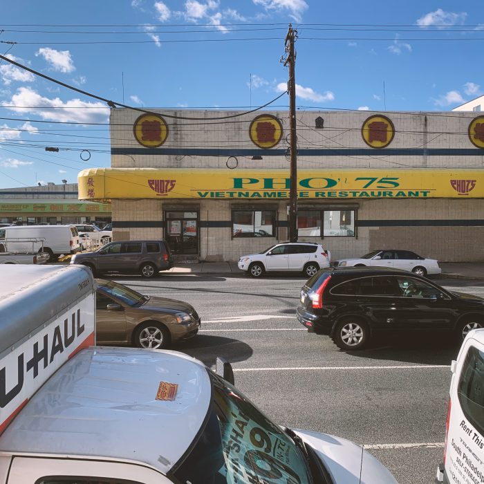 Cars drive in front of PHO 75 restaurant